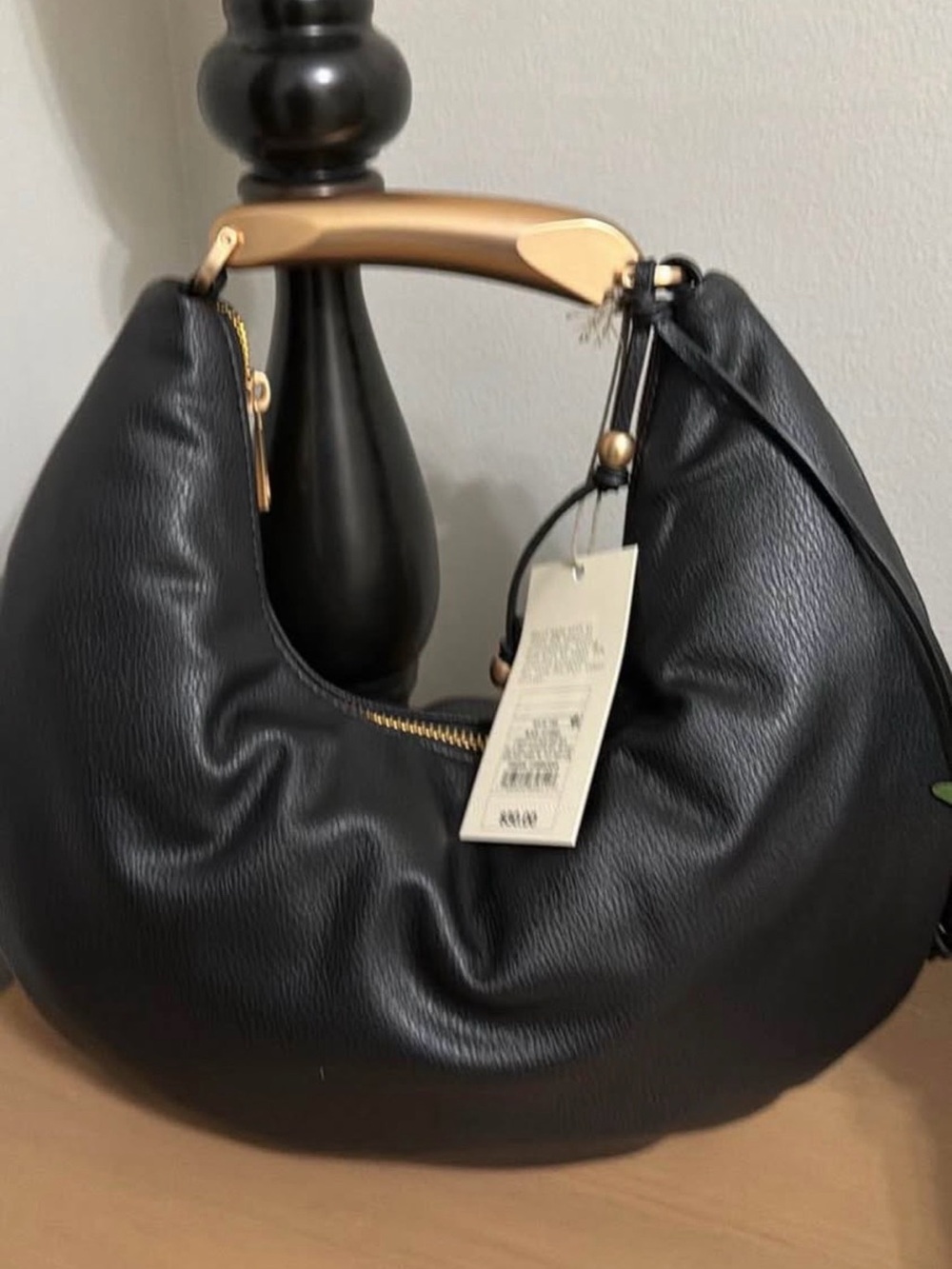 Elegant Black Crescent Bag with Gold Accent Handle